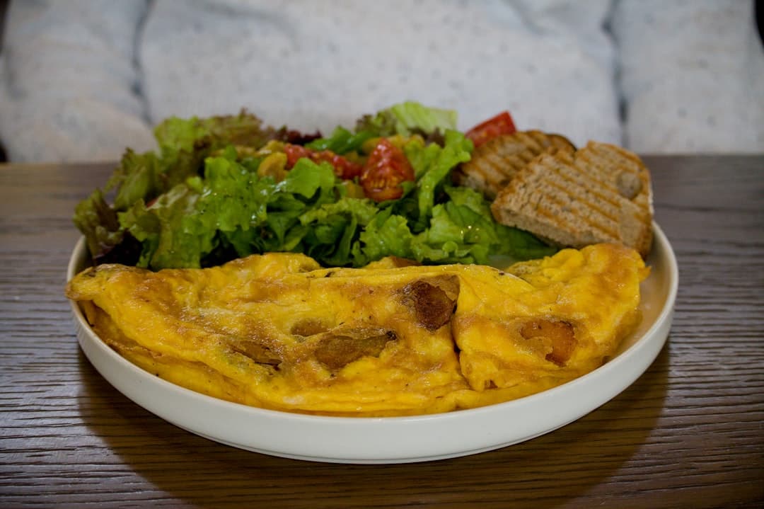 Omelette with salad and toast served on a plate