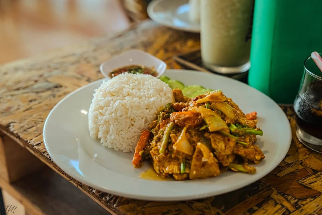 Plate of rice and curry with vegetables