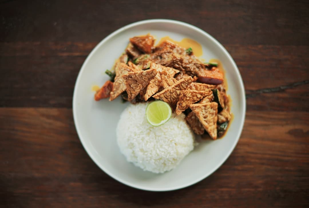 cooked meat with rice served on white plate