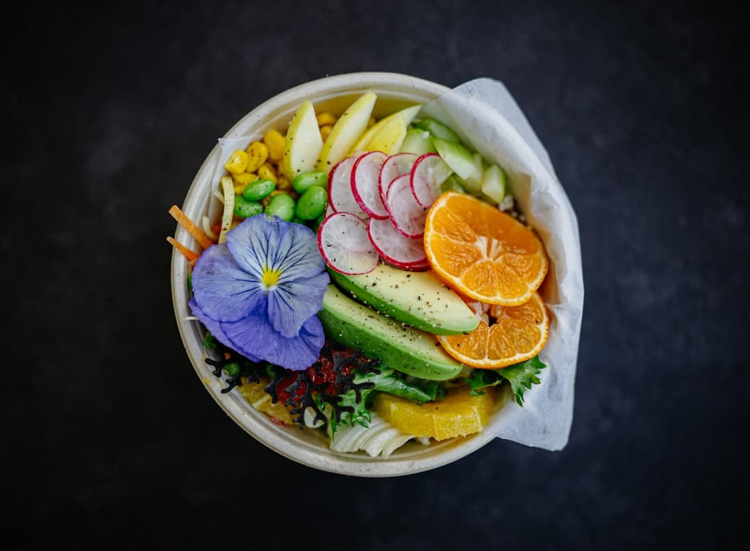 a bowl filled with fruit and vegetables on top of a table