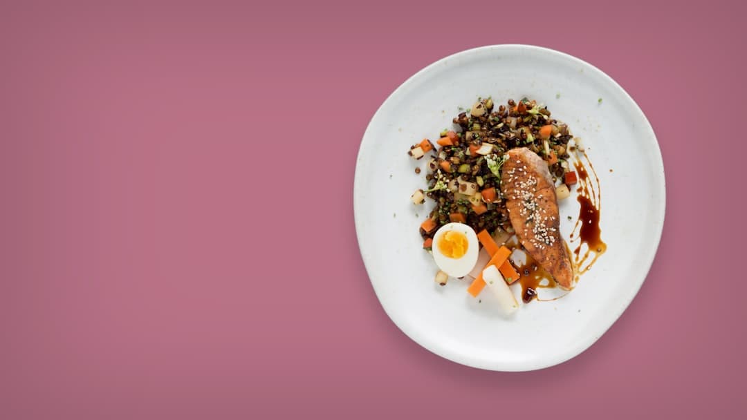 a white plate topped with meat and vegetables