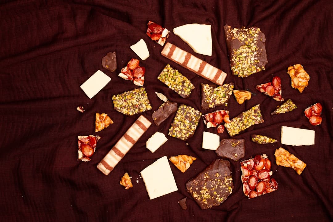 Assortment of broken chocolate bars and sweets on fabric